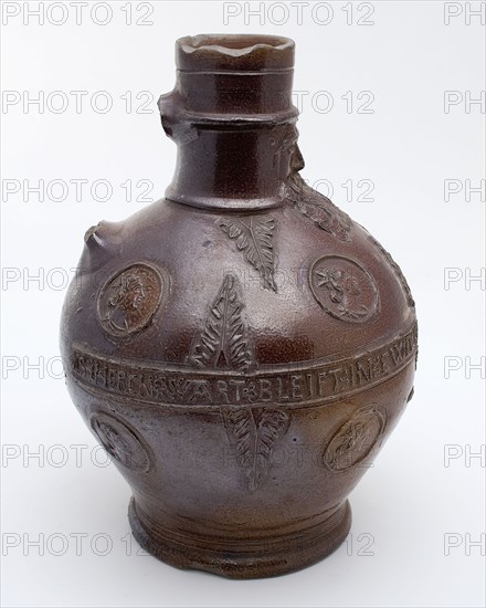 Dark brown bearded jug, round belly frieze with text, portrait medallions and acanthus leaves, beard masonry vessel holder soil