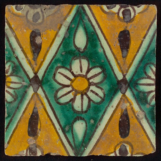 Floor tile, brown draft, green and yellow on white ground, central green oblique glass in which white flower with yellow heart