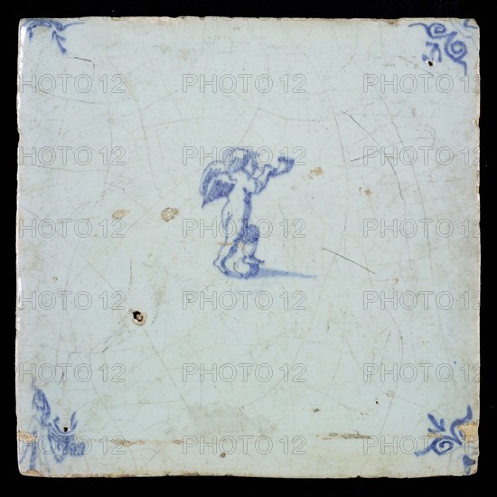 White tile with blue putto with wind instrument; corner pattern ox head, wall tile tile sculpture ceramic earthenware glaze