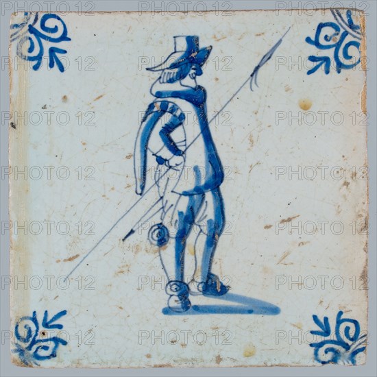 White tile with blue warrior with spear; corner pattern ox head, two shades of blue, wall tile tile sculpture ceramic