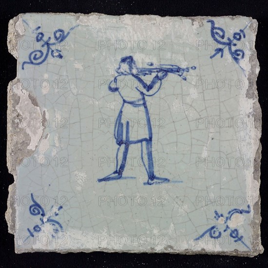 White tile with blue warrior shooting with crossbow; corner pattern ox head, wall tile tile sculpture ceramic earthenware glaze