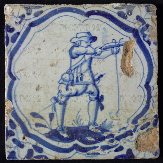 White tile with blue warrior in accolade-shaped frame, corner motif wing leaf, wall tile tile sculpture ceramic earthenware