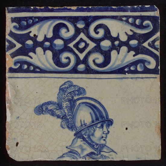 Tile of tableau with blue decorated border and helmeted head of soldier, tile picture footage fragment ceramic pottery glaze