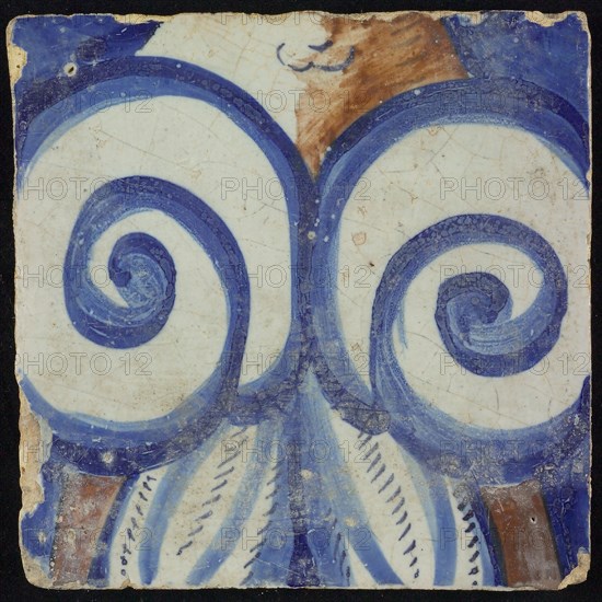 Tile of chimney pilaster, blue and brown on white, central two spiral ornaments, above part of neck of person, shadow in brown