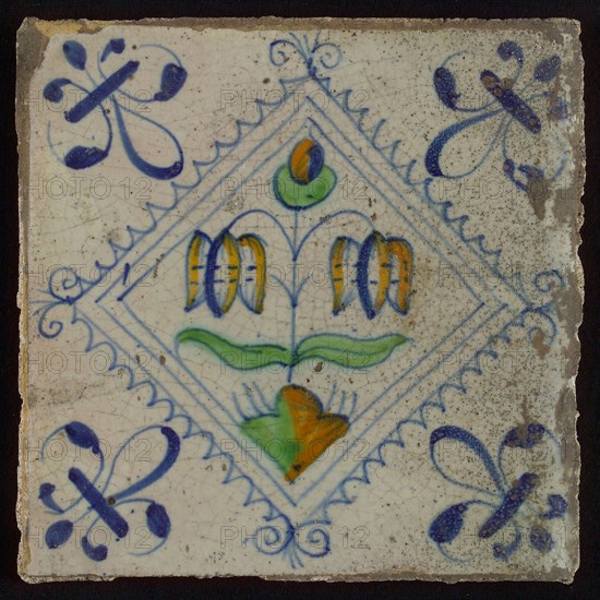 Tile, double flower on small ground in orange, green and blue on white, inside serrated square with plume, corner pattern french