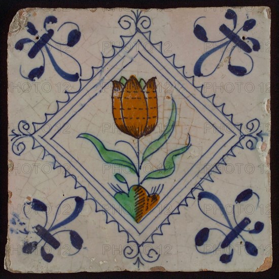 Tile, tulip on ground in orange, green and blue on white, inside serrated square with plume, corner pattern french lily, wall