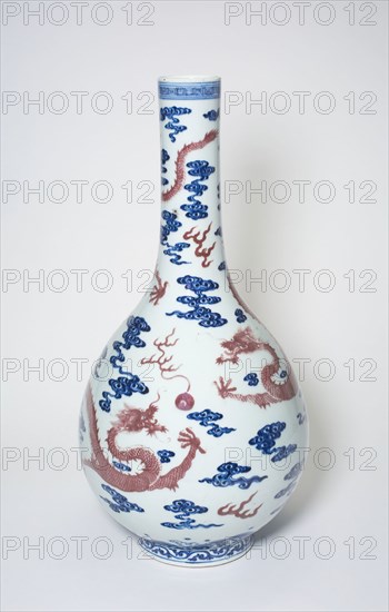 Long-Necked Vase with Dragons Chasing Flaming Pearls among Stylized Clouds, Qing dynasty (1644–1911), 18th century, China, Porcelain painted in underglaze blue and copper red, H. 47.3 cm (18 5/8 in.), diam. 23.7 cm (9 5/16 in.)