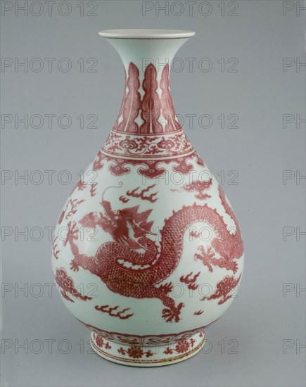 Bottle Vase with Dragons amid Clouds, Chasing Flaming Pearls, Pendant Ruyi, Lingzhi Scrolls, Upright Leaves and Petal Panels, and Florets Encircling Foot, Qing dynasty (1644–1911), Qianlong reign mark and period (1736–1795), China, Porcelain painted in underglaze red, H. 31.0 cm (12 3/16 in.), diam. 19.0 cm (7 1/2 in.)