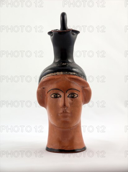 Oinochoe (Pitcher) in the Shape of a Female Head, about 450 BC, Greek, Athens, Attributed to the Canessa Class, Athens, terracotta, decorated in the red-figure technique, 14 × 6.7 × 8.9 cm (5 1/2 × 2 5/8 × 3 1/2 in.)