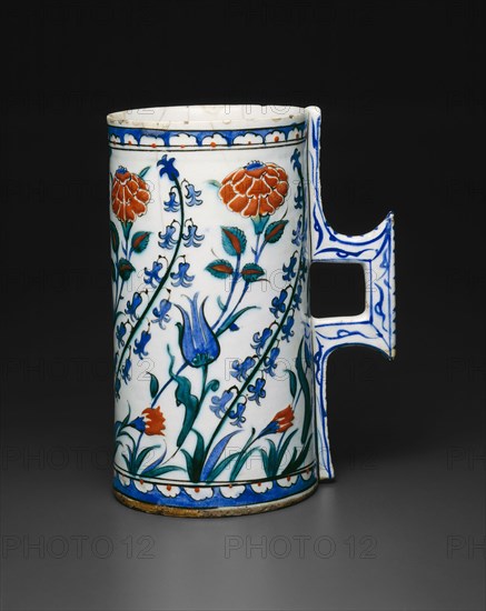 Tankard (Hanap) with Tulips, Hyacinths, Roses, and Carnations, Ottoman dynasty (1299–1923), late 16th century, Turkey, Iznik, Turkey, Fritware with underglaze painting in blue, turquoise, red, and black, 19.6 × 15 × 10.5 cm (7 3/4 × 5 7/8 × 4 1/8 in.)