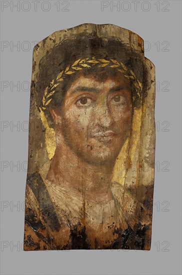 Mummy Portrait of a Man Wearing a Laurel Wreath, Early to mid–2nd century AD, Roman, The Fayum, Egypt, Fayum, Lime (linden) wood, beeswax, pigments, gold, textile, and natural resin, 41.9 × 24.1 × 0.2 cm (16 1/2 × 9 1/2 × 1/16 in.), depth with support 5.7 cm (2 1/4 in.)