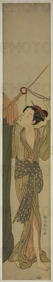 Hanging Up a Mosquito Net, c. 1767/68, Suzuki Harunobu ?? ??, Japanese, 1725 (?)-1770, Japan, Color woodblock print, hashira-e, 26 1/2 x 4 5/8 in.