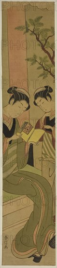 Osen of the Kagiya teahouse and an assistant reading a novelette, c. 1769/70, Suzuki Harunobu ?? ??, Japanese, 1725 (?)-1770, Japan, Color woodblock print, hashira-e, 25 x 5 in.
