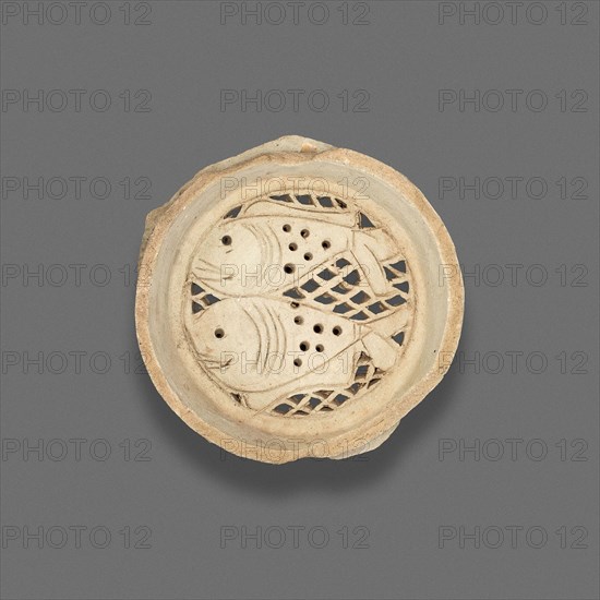 Clay filter with design of fish, Fatimid dynasty (969–1171), 11th–12th century, Egypt, Fustat, Masr al-`Atiqah, Earthenware, carved and punched, .75 × 7.3 cm (3/4 × 2 7/8 in.)