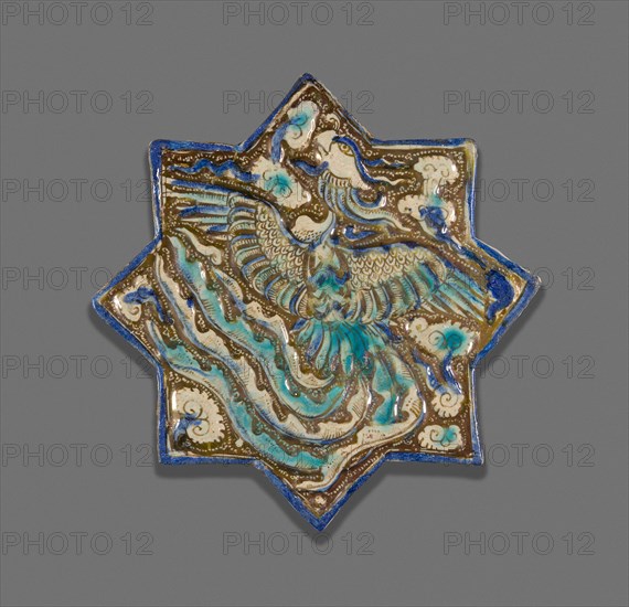 Star-Shaped Tile with Phoenix, Ilkhanid dynasty (1256–1353), late 13th century, Iran, possibly Takht-i Sulayman, Iran, Fritware with molded decoration, in-glaze painting in blue and turquoise, and overglaze painting in luster, 21.2 × 21.8 × 1.2 cm (8 5/16 × 8 9/16 × 1/2 in.)