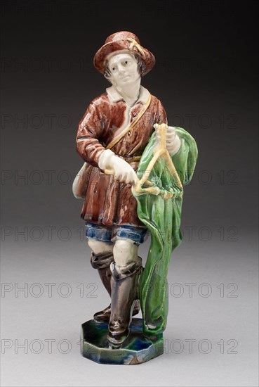 The Triangle Player, Early 17th century, France, Avon or Fontainebleu, Possibly after a model by Guillaume Dupéé (French, 1579-1640), Avon, Tin-glazed earthenware, 22 × 8.9 × 7.5 cm (8 5/8 × 3 1/2 × 2 15/16 in.)