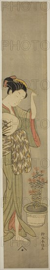 Beauty Adjusting Her Hairpin, c. 1768/69, Suzuki Harunobu ?? ??, Japanese, 1725 (?)-1770, Japan, Color woodblock print, hashira-e, 64.5 x 11.4 cm (26 3/8 x 4 1/2 in.)