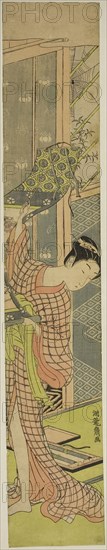 Young Woman Hanging a Painting, c. 1771, Isoda Koryusai, Japanese, 1735-1790, Japan, Color woodblock print, hashira-e