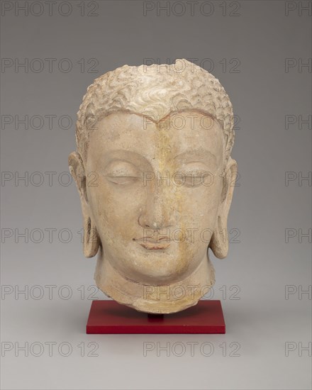 Head of Buddha, Kushan period, 3rd–5th century, Afghanistan or Pakistan, Ancient region of Gandhara, Gandhara, Stucco with traces of red pigment, 18.2 × 11.0 × 11.7 cm (7 3/16 × 4 15/16 × 4 5/8 in.)