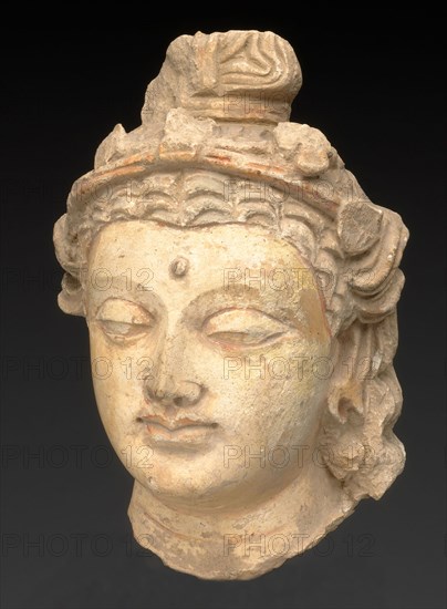 Head of a Bodhisattva, Kushan period, About 3rd/5th century, Present-day Afghanistan or Pakistan, Ancient region of Gandhara, Gandhara, Stucco with traces of red pigment, 20.4 × 13.5 × 10.8 cm (8 × 5 5/16 × 4 1/4 in.)