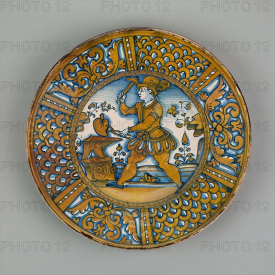 Display Plate with a Man Striking a Heart on an Anvil, c. 1550, Italian, Deruta, Deruta, Tin-glazed earthernware with copper luster (maiolica), Diameter: 40 cm (15 3/4 in.), H: 9.5 cm (3 3/4 in.)