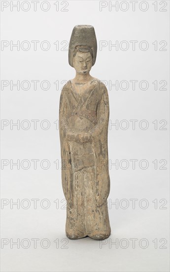Standing Attendant, Style of Nothern Wei, early 6th century, China, Shanxi, Earthenware with traces of polychrome pigment, 18.0 x 4.3 x 3.5 cm (7 1/16 x 1 11/6 x 1 3/8 in.)