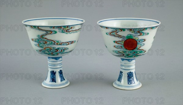 Pair of Stem Cups with Sun amid Clouds and Stylized Characters for Long Life (Shou), Qing dynasty (1644–1911), Yongzheng reign mark and period (1723–1735), China, Porcelain painted in underglaze blue and overglaze enamels (doucai), H. 8.7 cm (3 7/16 in.), diam. 8.0 cm (3 1/8 in.)