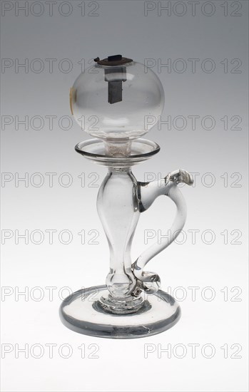 Lamp, c. 1820, England, Glass, clear, baluster stem, spherical font, with S-scroll handle and metal wick holder, 21 × 9.5 cm (8 1/4 × 3 3/4 in.)