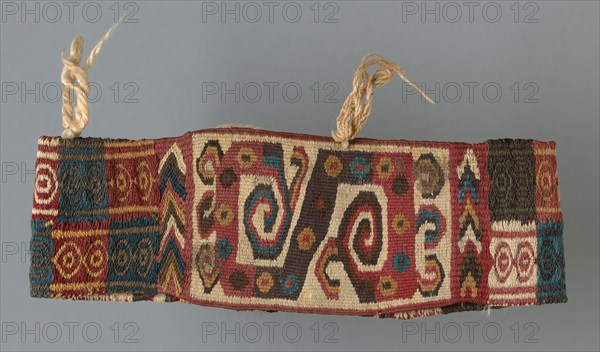 Headband, A.D. 600/900, Wari, Probably central or south coast, Peru, Peru, Cotton and wool (camelid), bands of single interlocking tapestry weave, plain weave, and two-color complementary weft weave, attached cotton tassels, 13.0 x 23.7 cm (5 1/8 x 9 3/8 in.)