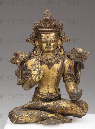 Bodhisattva Avalokiteshvara Seated with Hand in Gesture of Reassurance (Abhayamudra), 15th/16th century, Nepal, Nepal, Gilt bronze with gemstones, 17.5 x 10.1 x 7.4 cm (6 7/8 x 4 x 3 in.)
