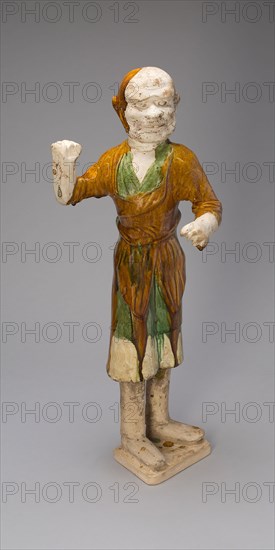 Groom, Tang dynasty (618–907 A.D.), first half of 8th century, China, Earthenware with three-color (sancai) lead glazes and traces of pigments, 58.5 × 25.0 × 17.5 cm (23 × 9 13/16 × 6 7/8 in.)
