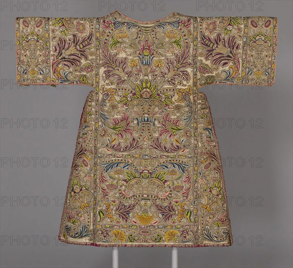 Dalmatic, 17th century, Spain or Italy, Spain, Silk, plain weave with twill interlacings of secondary binding warps and silvered-metal wire facing wefts, underlaid with linen, plain weave, embroidered with silk, gilt-metal purl and gilt-metal-strip-wrapped silk in brick, overcast and split stitches, laid work, couching, padded couching and French knots, edged with silk and gilt- and silvered-metal-strip-wrapped silk, plain weave with supplementary patterning wefts and extended ground weft cut fringe, 118.2 x 127.7 cm (46 1/2 x 50 1/4 in.)
