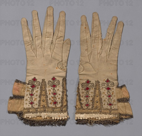 Pair of Gloves, 1601/50, England, Leather, cut, pricked and slashed, silk satin appliqué, gilt-metal-strip-wrapped silk couching, gilt-metal-strip-wrapped silk woven fringe, balls covered with gilt-metal-wrapped-silk, ribbons of silk, plain weave edged with gilt-metal-strip-wrapped silk woven fringe, lining: silk, plain weave, interlining: linen, plain weave, a: 30 × 14.6 cm (11 3/4 × 5 3/4 in.)