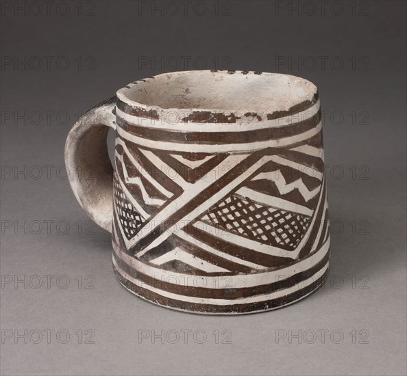 Mug with Interlocking Geometric Pattern with Zigzag Motifs and Crosshatching, A.D. 1100/1275, Ancestral Pueblo (Anasazi), Mesa Verde Black-on-white, Southwest, United States, Southwest, Ceramic and pigment, 11.4 x 9.5 cm (4 1/2 x 3 3/4 in.), Happi (Chair Cover), Meiji period (1868–1912), 1870/90, Japan, Silk, gold-leaf-over-lacquered-paper strip, warp-float faced 2:1 ‘Z’ twill weave with weft-float faced 1:2 ‘Z’ interlacings of secondary binding warps and supplementary patterning wefts, lined with silk, plain weave, 147.4 x 207 cm   (58 1/4 x 81 1/2 in.), Mizuhiki (Temple Banner), late Edo period (1789–1868), 1800/50, Japan, Silk and gold-leaf-over-lacquered-paper strip, warp-float faced 3:1 ‘Z’ twill weave with weft-float faced 1:3 twill interlacings of secondary binding warps and supplementary patterning wefts, 448.7 x 61 cm (176 5/8 x 24 in.)