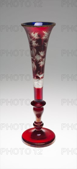 Vase, c. 1850/60, England, Glass and metal, formed in two parts and joined by a gilt metal (probably brass) collar at rim, the exterior, blown clear glass, stained ruby and engraved, the interior, blown cobalt blue glass, with the interiors of both parts silvered, 40.5 × 12.7 cm (15 15/16 × 5 in.)