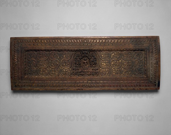 Manuscript Cover with Enshrined Sakyamuni Buddha with Hand in Earth Touching (Bhumisparsha) Mudra, 15th century, Tibet, Central Tibet, Tibet, Wood with traces of gilding, 25.2 x 70.8 x 3.9 cm (9 15/16 x 27 7/8 x 1 1/2 in.)