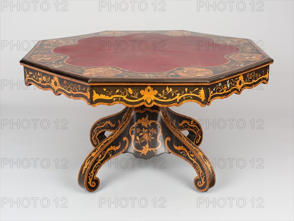 Octagonal Library Table, c. 1840, designed 1832, Attributed to Richard Hicks Bridgens, English, 1785-1846, Made by Edward Holmes Baldock, English, 1777-1845, London, England, London, Ebony, boxwood, kingwood, mahogany, satinwood, pine, cedar, chestnut, tulipwood, and various stained and shaded woods, with ivory, pearl-shell, copper and brass inlay, the carcass of the top and of the drawer linings is mahogany, the carcass of the base pedestal is pine, replacement leather, 74.9 x 137.2 x 148.6 cm (30 x 54 x 58 1/2 in.)