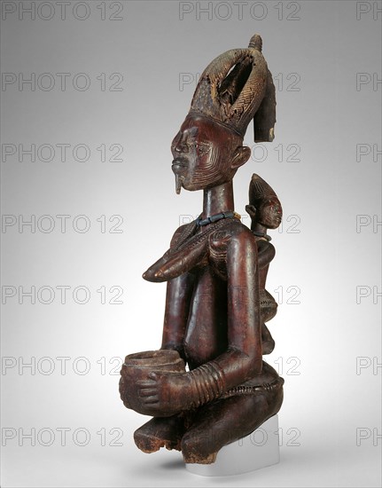 Female Figure with Bowl, Late 19th century, Abogunde of Ede (active late 19th century), Yoruba, Nigeria, Coastal West Africa, Wood, beads, and traces of pigment, 62.2 × 19 × 31.7 cm (24 1/2 × 7 1/2 × 12 1/2 in.)