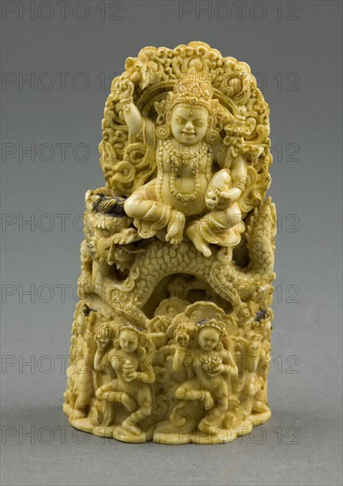 Jambhala, the God of Wealth, Seated on a Dragon, 15th century, Eastern Tibet, Tibet, Ivory with traces of gilding and pigment, 13.7 x 7.5 x 3.8 cm (5 3/8 x 3 x 1 1/2 in.), H. with pins: 15.3 cm (6 in.)
