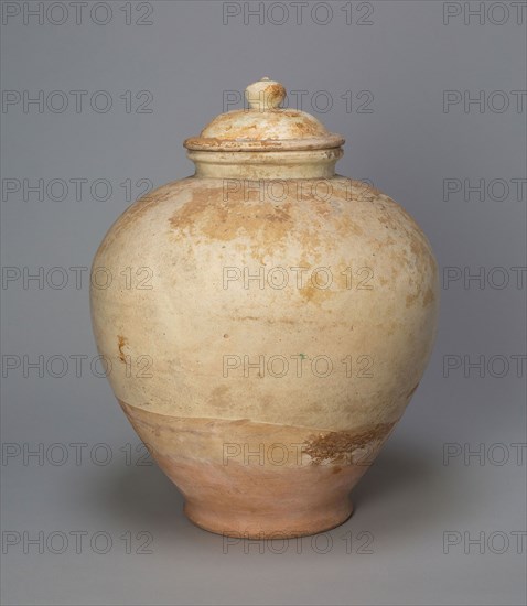 Covered Jar, Tang dynasty (618–906), early 8th century, China, Slip-coated earthenware, H. 35.6 cm (14 in.), diam. 27.6 cm (10 7/8 in.)