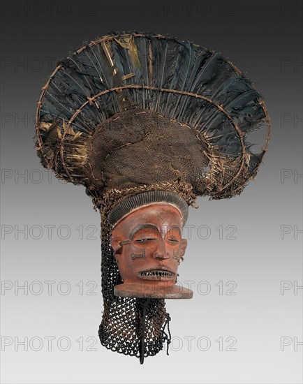 Male Face Mask (Chihongo), Mid–/late 19th century, Chokwe, Angola or Democratic Republic of the Congo, Central Africa, Angola, Wood, raffia, burlap, turaco feathers, guinea fowl feathers, and pigment, 73.7 × 48.3 cm (29 × 19 in.)