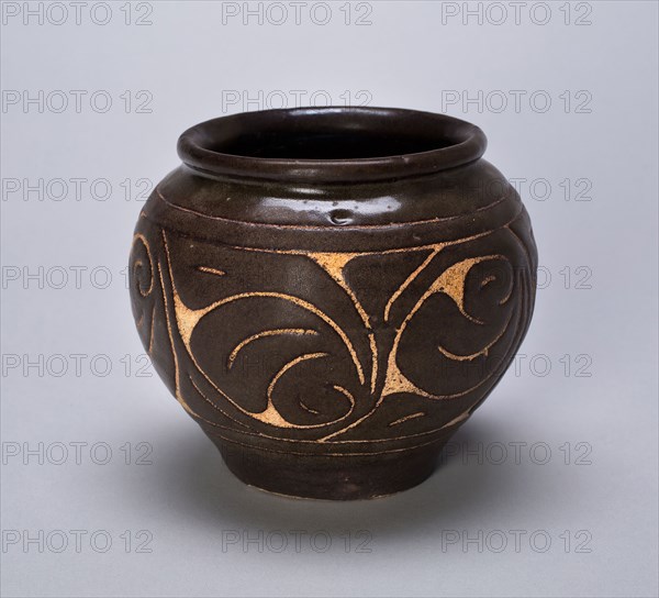 Small Globular Jar with Rolled Lip and Stylized Leaves, Jin dynasty (1115–1234), China, Cizhou ware, stoneware with carved-slip decoration, H. 9.7 cm (3 7/8 in.), diam. 11.2 cm (4 1/2 in.)