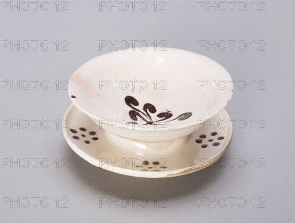 Cup and Stand, Jin dynasty (1115–1234), China, Cizhou type ware, glazed stoneware with iron-brown spots on saucer, abstract floret in bowl, H. 4.2 cm (1 11/16 in.), diam. 7.6 cm (3 in.)