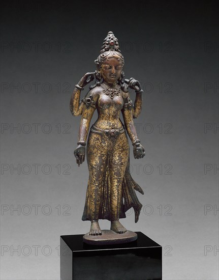 Sarasvati, Goddess of Wisdom, Holding a Book and a Water Pot, 10th century, Nepal, Kathmandu Valley, Kathmandu Valley, Gilt copper alloy with semiprecious stones, 22.9 x 8 x 5.1 cm (9 x 3 1/8 x 2 in.)
