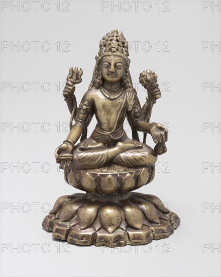 Four-Armed Bodhisattva Avalokiteshvara Seated in Lotus Position (Padmasana), 8th/9th century, Pakistan, Khyber Pakhtunkhwa Province, Swat Valley, Pakistan, Brass inlaid with silver and copper alloy, 15.9 x 10.3 x 8.8 cm (6 1/4 x 4 1/6 x 3 7/16 in.)