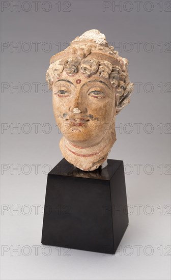 Head of a Bodhisattva, 3rd/5th century, Afghanistan or Pakistan, Ancient region of Gandhara, Gandhara, Stucco with red and black pigment, 14 × 8.5 × 10.2 cm (5 1/2 × 3 5/16 × 4 in.)