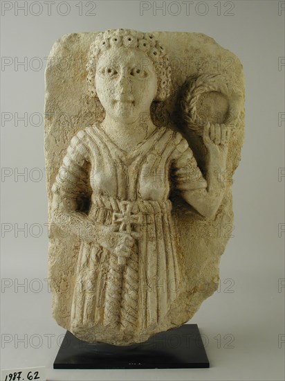 Coptic, Egyptian, Relief of Saint Holding Wreath, 4th/7th Century AD, Limestone, 14 1/4 x 9 1/4 x 5 1/4 in. (36.20 x 23.5 x 13.34 cm)