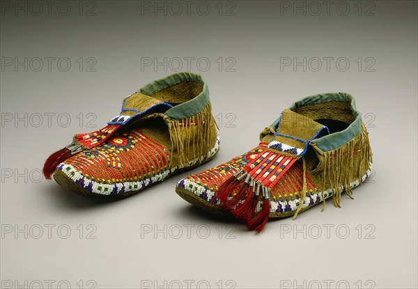 Sioux, Native American, Pair of Moccasins, ca. 1900, cowhide, rawhide, porcupine quills, glass beads, cotton fabric, tin cones, and dyed horsehair, Overall (left moccasin): 10 3/4 × 4 1/8 × 4 1/2 inches (27.3 × 10.5 × 11.4 cm)