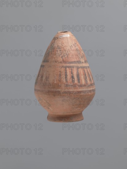 Bottle, Egyptian workshop, Coptic painted pottery, painted pottery, geometric decorations. Low, wide, annular foot; belly walls widely flared at the bottom, bent inward at approximately one-third of the vessel; neck reflected. Decoration painted in black and white, banded. Below the neck, a zigzag band painted in white, adorned with a diagonal black check motif; below, a strip of vertical lines painted alternately with black and white paint, framed at the top and bottom by double black stripes. LRO type item. Nile clay, low porosity, with distinct golden mica flakes. 6th century, Egypt; vessel. Height 17.5 cm; width 11 cm body; diameter 8 cm outer rim., A rounded ceramic vessel with a narrow mouth and a flared foot sits centered against a plain gray background; the vessel shows an overall earthy terracotta color with worn patches and a weathered surface, decorated with darker brown to black painted bands and vertical strokes around its midsection and upper area, and lighter beige areas...