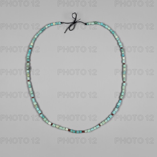 Necklace, Necklace consisting of 97 cylindrical blue-glazed faience beads, interwoven with 13 spherical, slightly flattened beads of red glass. 4th–6th century; Post-Meroitic period. Found at Ashkot salvage excavations, 4th Cataract, Sudan, context: 1/T2, chamber, southern part. Jewelry., A simple looped strand of small square and cylindrical beads laid flat on a pale gray background, the beads forming an oval with a tied black cord at the top; the beads show a range of turquoise and light blue shades with patches of green and some beads in a dark reddish-brown, and a few beads that appear paler or more off-white.